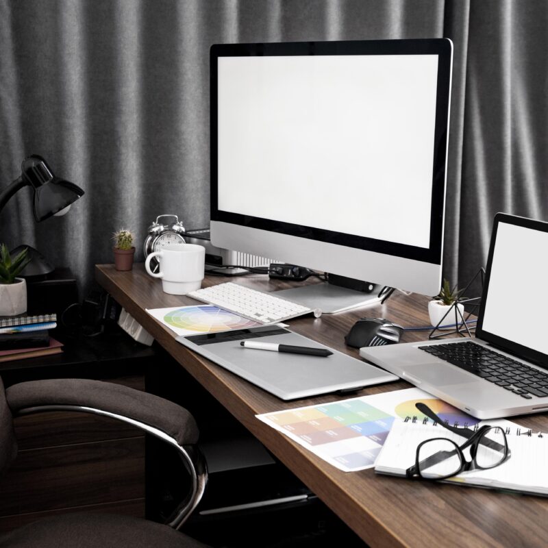 Desk with computer and laptop